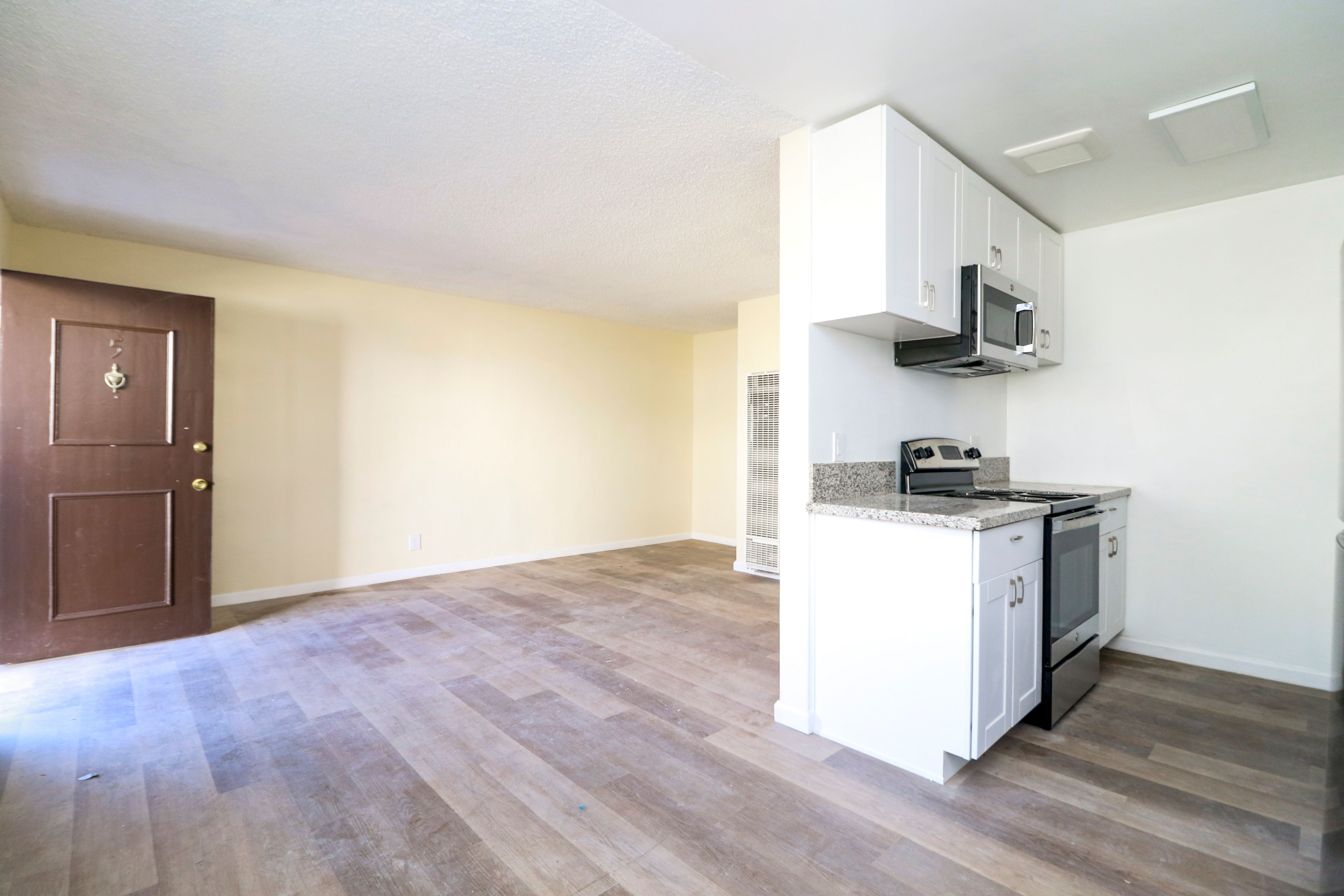 A kitchen with a microwave above the counter.